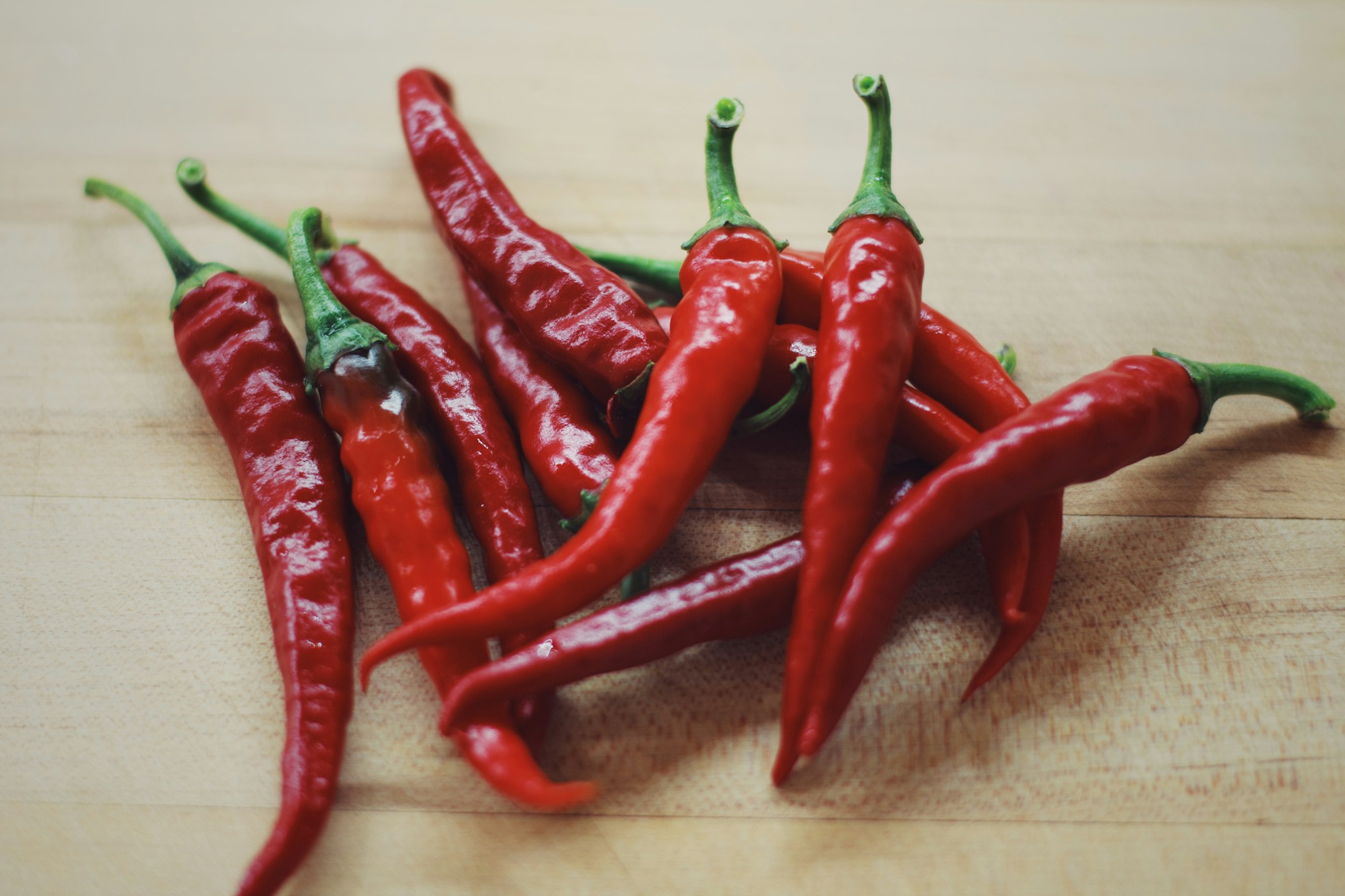 Assorted red hot peppers on a cutting board