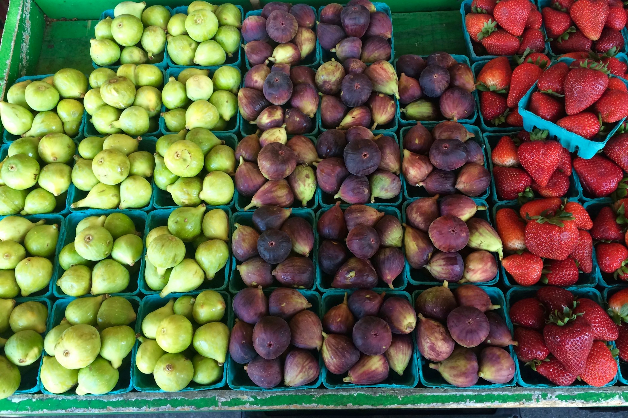 Colorful market fruits, including figs