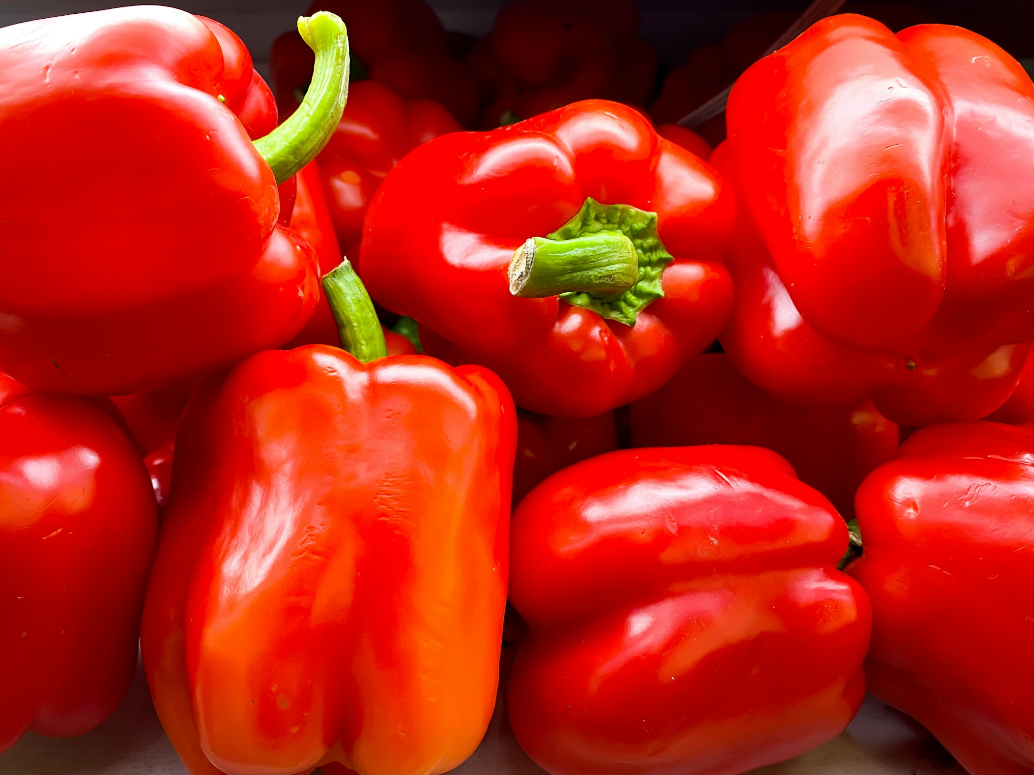 Colorful sweet bell peppers in the basket at the supermarket